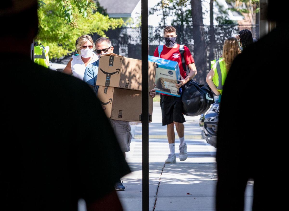 Wearing masks and following various protocols in an attempt to protect them from the coronavirus pandemic, students began moving into campus housing at Coastal Carolina University today. Over 4,000 students have elected to live on campus this semester and will continue moving in over the next few weeks. August 12, 2020.