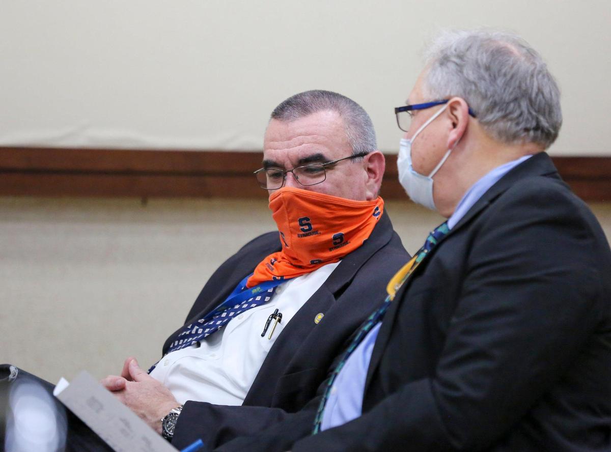 City Manager John Pedersen (left) talks with Deputy City Manager Jonathan “Fox” Simons during a special city council meeting in which the council ultimately decided to enter into negotiations with Simons for the job of City Manager when Pedersen retires this year. December 17, 2020.