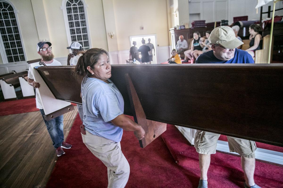 Church members and residents from the local community came together to move the pews and other contents of Trinity United Methodist to higher ground on on Tuesday ahead of what is expected to be record flooding from the Waccamaw River due to Hurricane Florence’s rains. September 18, 2018.