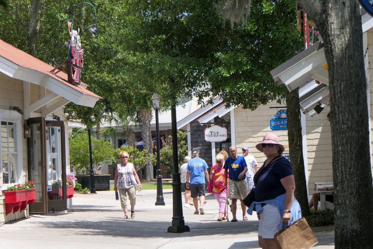 Shoppers stroll through the Barefoot Landing shopping and entertainment district in North Myrtle Beach, S.C. May 29, 2024.