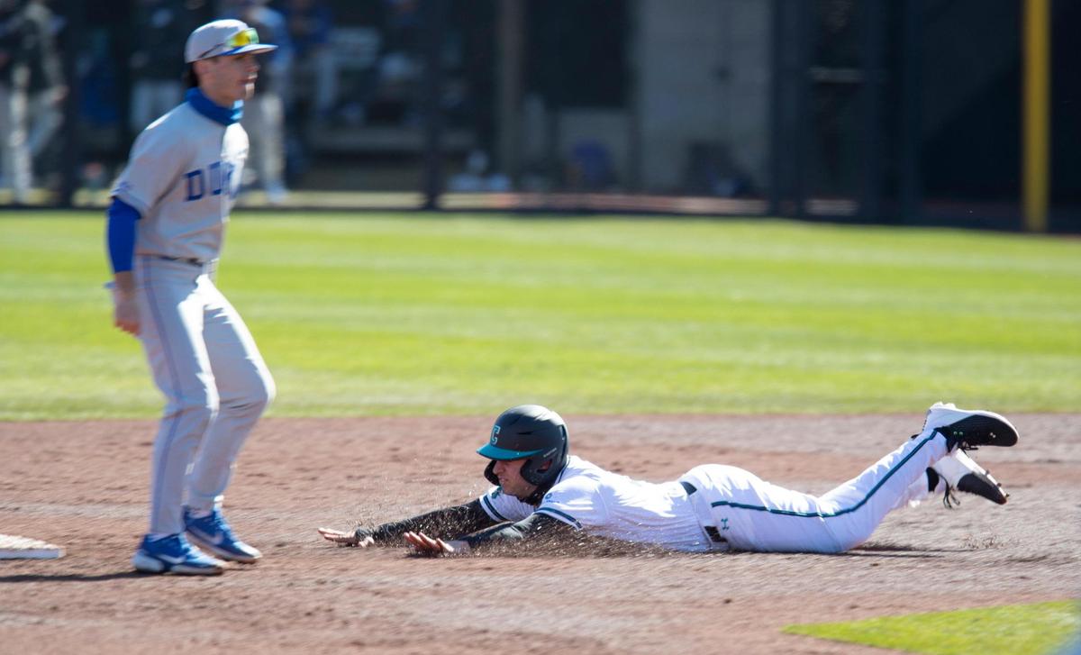 Coastal Carolina’s B.T. Riopelle (25) slides safely into second base during the Chanticleers’ season opener against Duke Saturday at Springs Brooks Stadium in Conway.