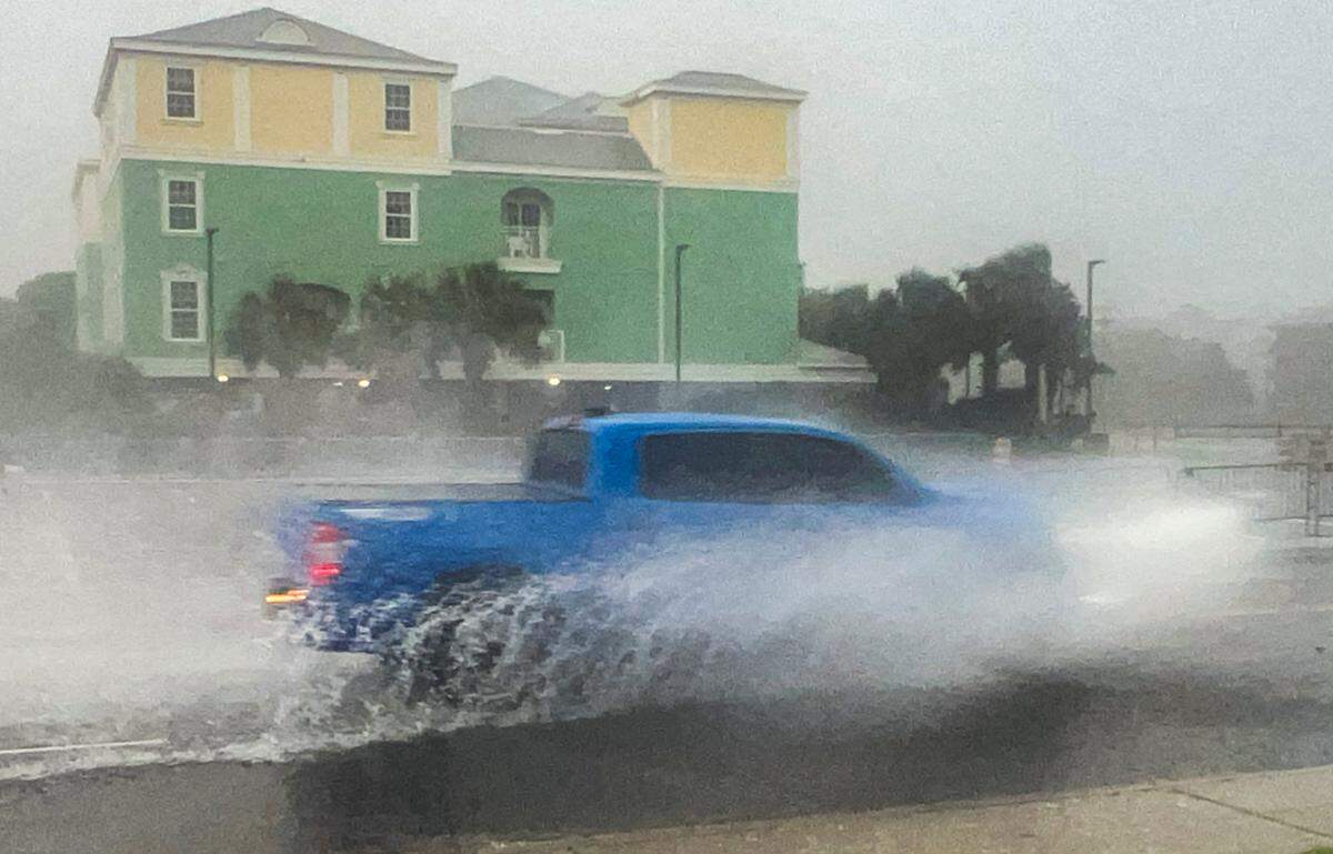 A truck drives through ponding water on Ocean Boulevard in North Myrtle Beach. As Tropical Storm Debby begins to impact the Myrtle Beach area with wind and rain, residents and visitors are making final preparations for what forecasters predict will be a long storm with significant flooding. Aug. 6, 2024.