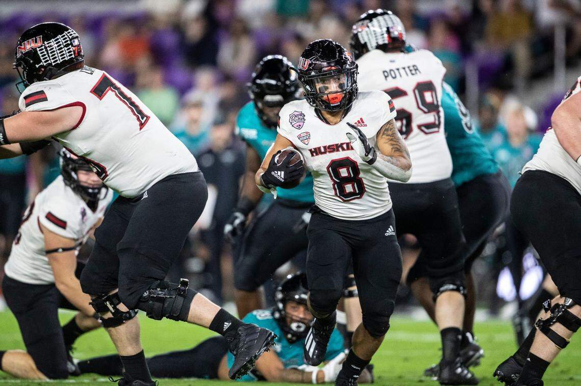 Northern Illinois running back Jay Ducker (8) runs the ball against Coastal Carolina during the Cure Bowl NCAA college football game in Orlando, Fla., Friday, Dec. 17, 2021. (Willie J. Allen Jr./Orlando Sentinel via AP)