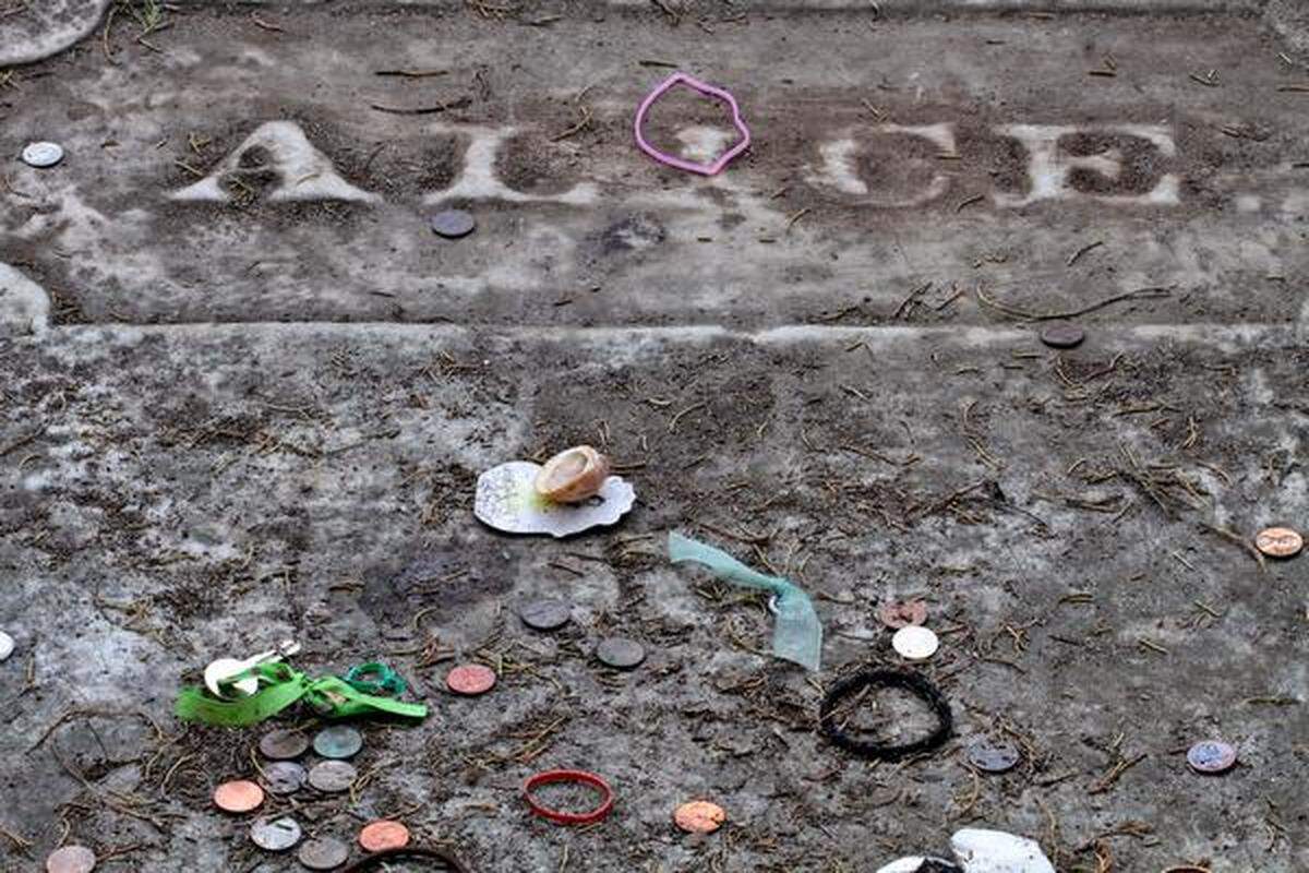 Shells, coins and other trinkets decorate the grave grave of Alice Flagg at the All Saints Episcopal Cemetery in Pawleys Island. Photo by Steve Jessmore sjessmore@thesunnews.com
