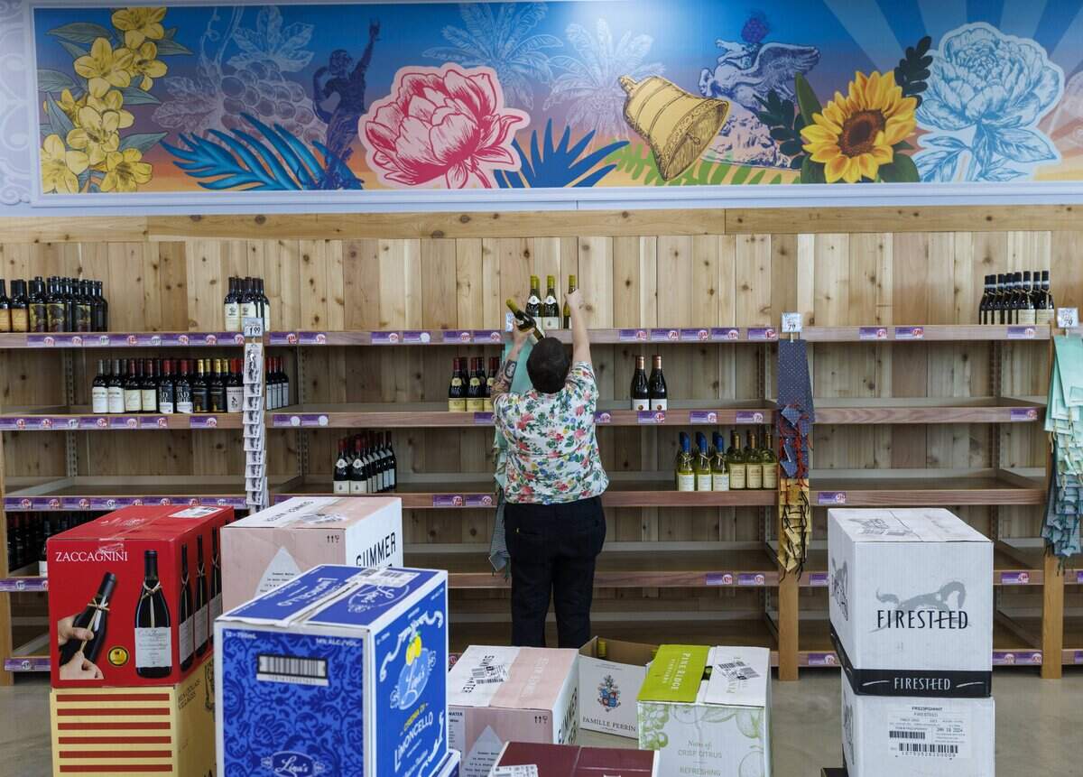 A Trader Joe’s crew member stocks shelves at the first Trader Joe’s in the Grand Strand.