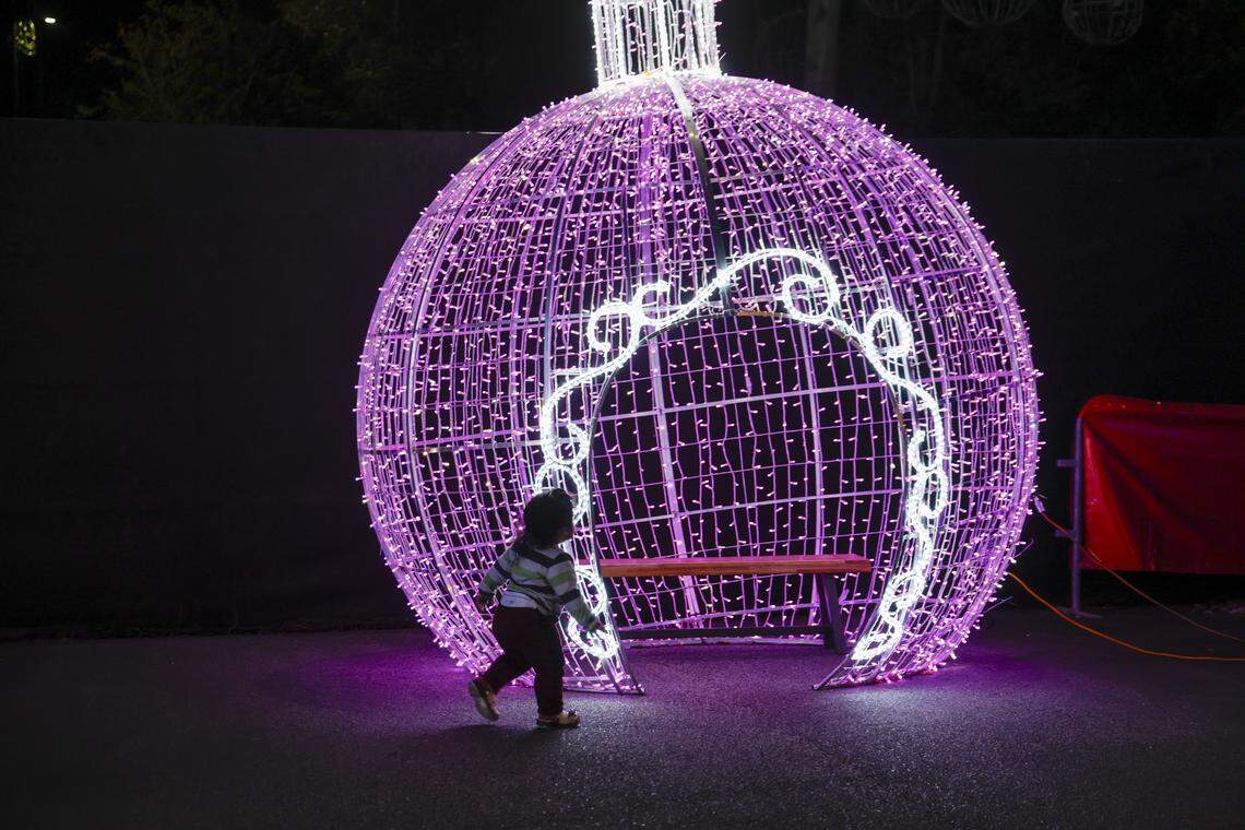 A child plays in Santa’s Village on Thursday night as final preparations are being made for North Myrtle Beach’s largest light show at the North Myrtle Beach Park and Sports Complex. The event opens November 24, 2025.