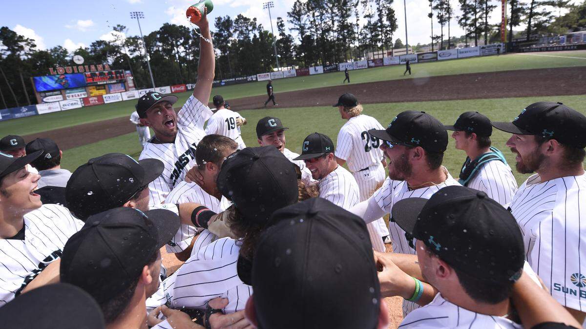 Coastal Carolina players storm the field to celebrate winning the 2018 Sun Belt Conference Baseball Tournament in Lafayette, La.