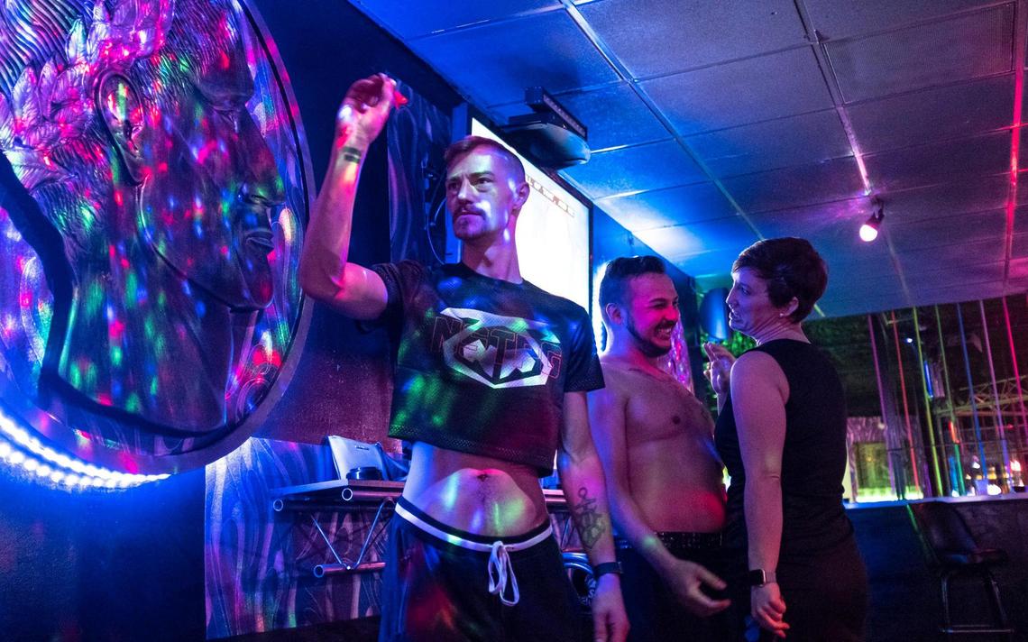 From left, Nicklas Barham, of Charleston, throws darts at the Pulse Ultra Club during a visit to the Grand Strand to see drag performer Nytes Deville and friend Mallary Hitchcock. Pulse, Myrtle Beach’s only gay nightclub, is fighting to outlast the coronavirus pandemic, which has ravaged the local tourism economy, especially bars. January 15, 2021.