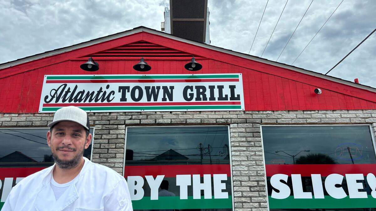 Mohamed Alkassar stands in front of his restaurant Atlantic Town Grill. The pizza place is the first new restaurant to open in Atlantic Beach in years.