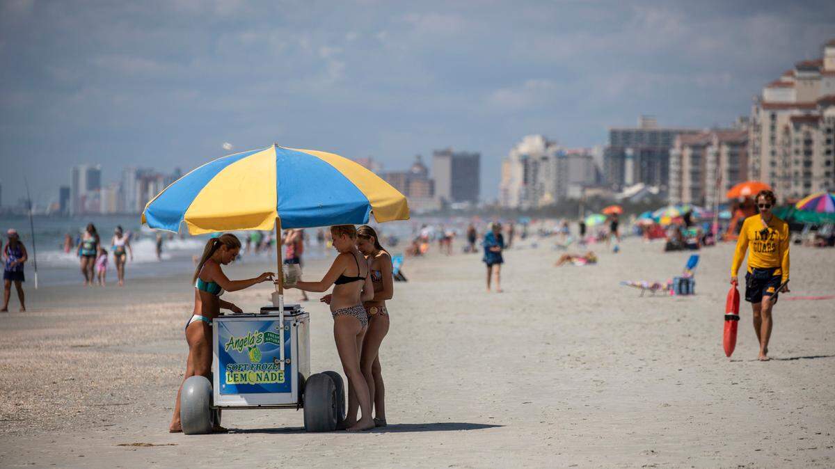 A vendor sales frozen lemonade on the Arcadian Shores section of Horry County with the Myrtle Beach skyline in the background. The week of Memorial Day marks the unofficial beginning of the tourist season along Grand Strand Beaches. May 31, 2022.