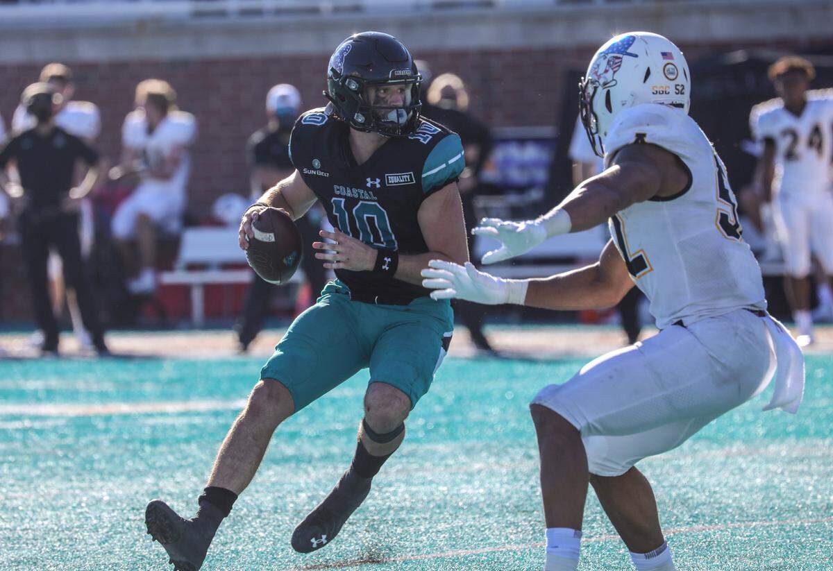 Coastal Carolina QB Grayson McCall looks for a receiver under pressure from Appalachian State in a win earlier this season. The Mountaineers had dominated Coastal and the rest of the Sun Belt conference for the past several years.