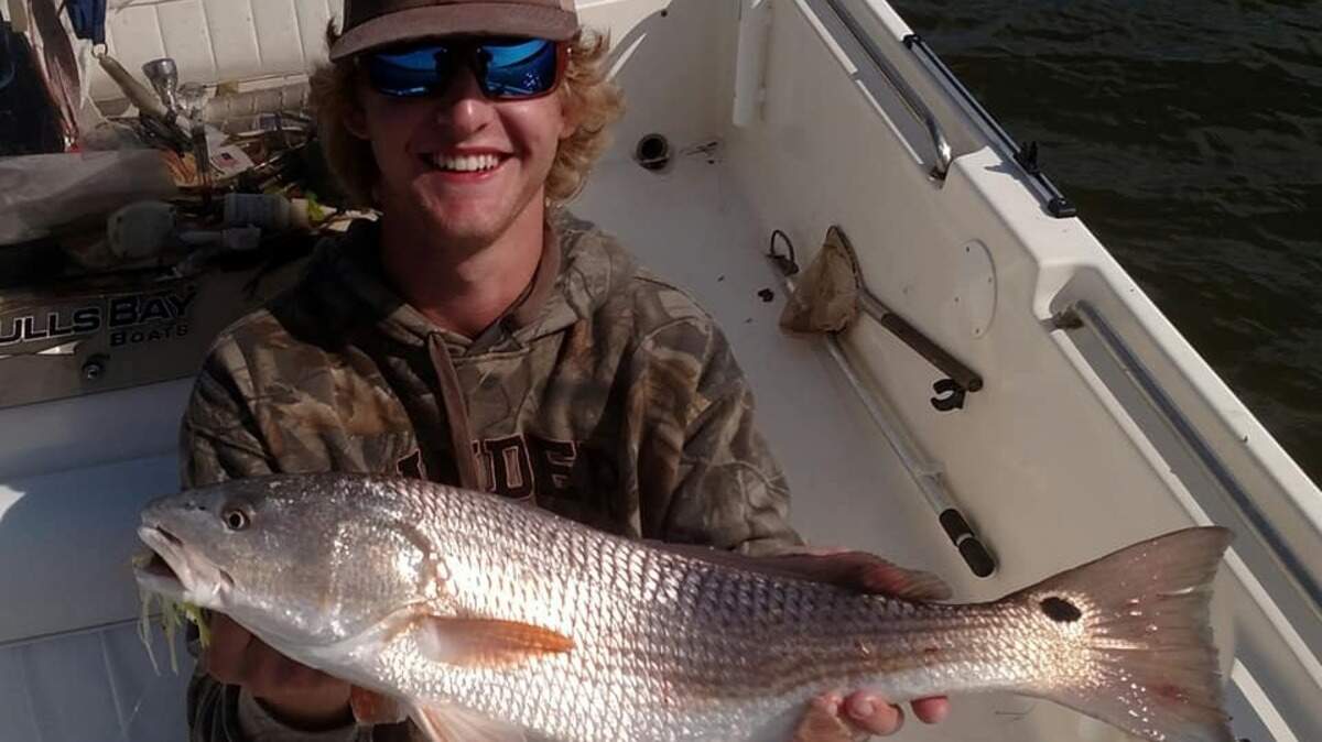 Nathan Richardson of Conway shows off a red drum caught in the Winyah Bay vicinity Wednesday with Capt. Mike McDonald of Gul-R-Boy Guide Service.