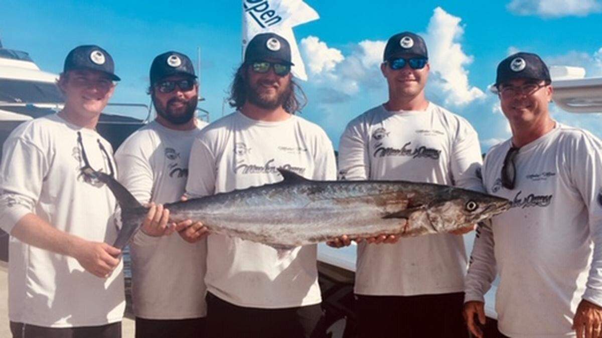 A crew out of Marlin Quay Marina in 2018 displays a large king mackerel. The migratory king mackerel arrived in local waters this week.