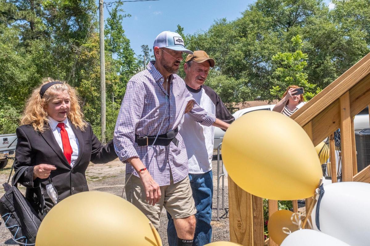Chad Hardee is led up the steps into his home by his father Samuel Hardee as he returns home after nearly six months of hospitalization on Friday. His continued recovery from COVID Pneumonia has been called a miracle by his family and friends. May 28, 2021.