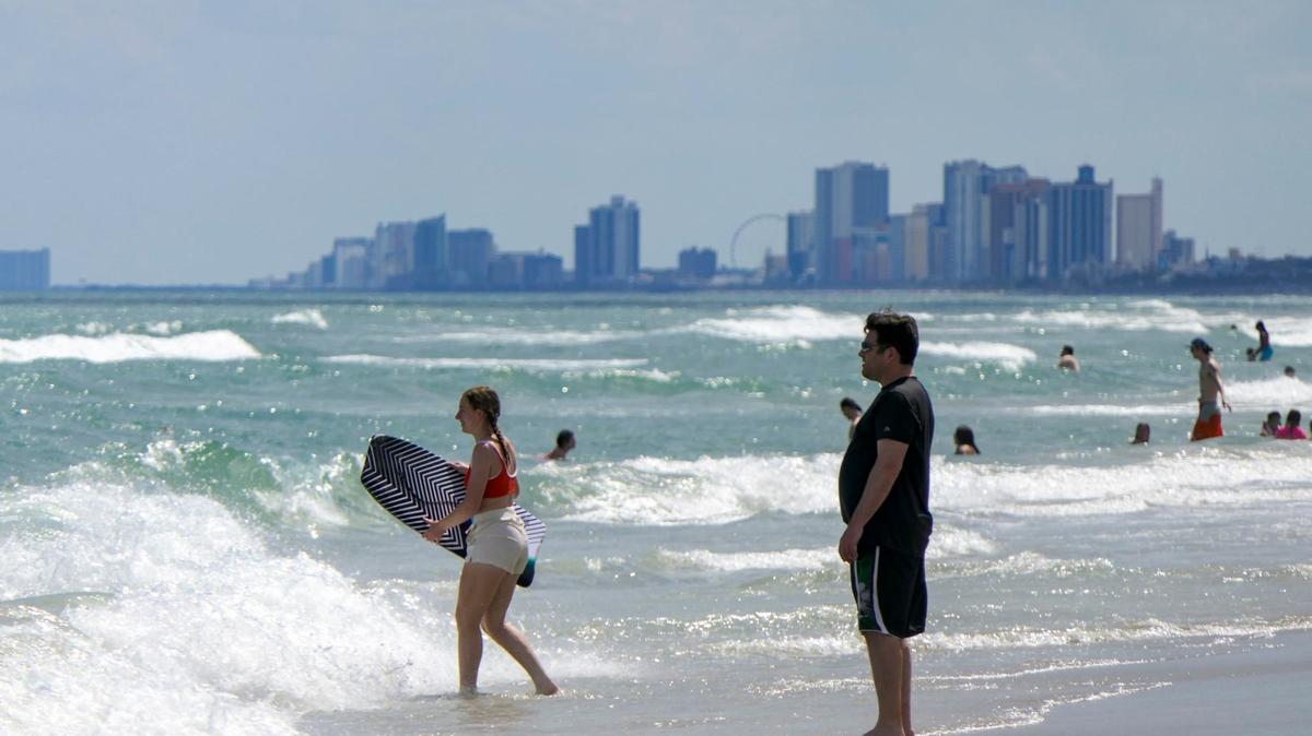 People enjoy the beach in the Myrtle Beach area. Part of the beach will close for around six months for outfall construction.