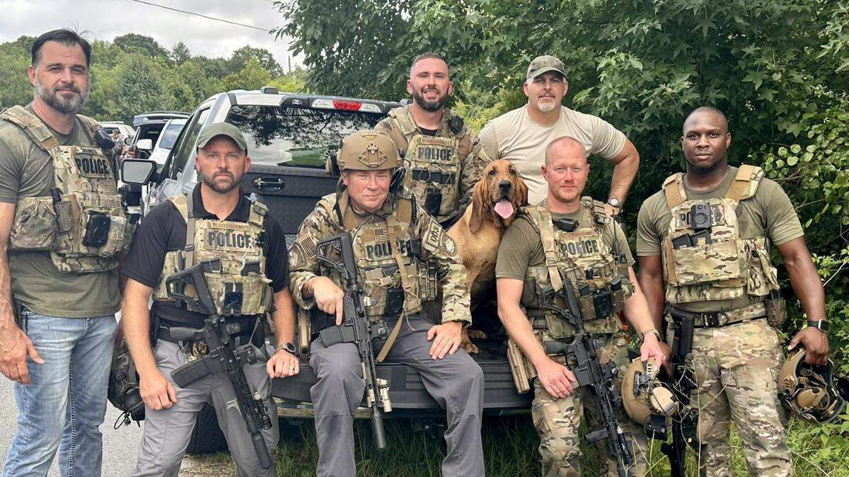 Horry County Police’s Bloodhound Team pose with K-9 Reba, who was used to track down a shooting suspect Aug. 4 off of Highway 707.
