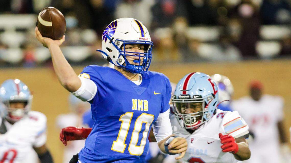 North Myrtle Beach Chiefs quarterback Cameron Freeman (10) passes as AC Flora Falcons linebacker Tyrell Green (2) closes in during the first half the state championship game at Benedict College.