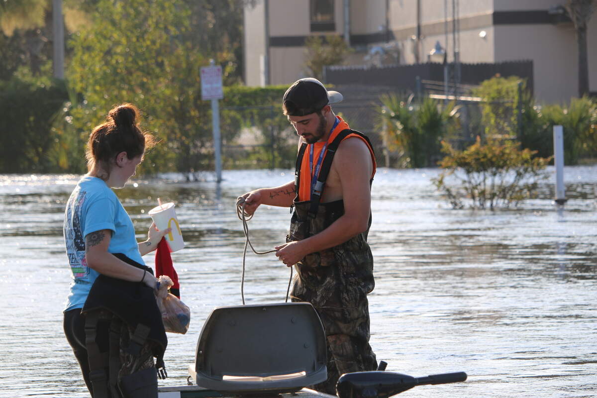Caption: Emy Chamberlain and her fiance Brenden Wellings get on the boat to head to their home for the evening.