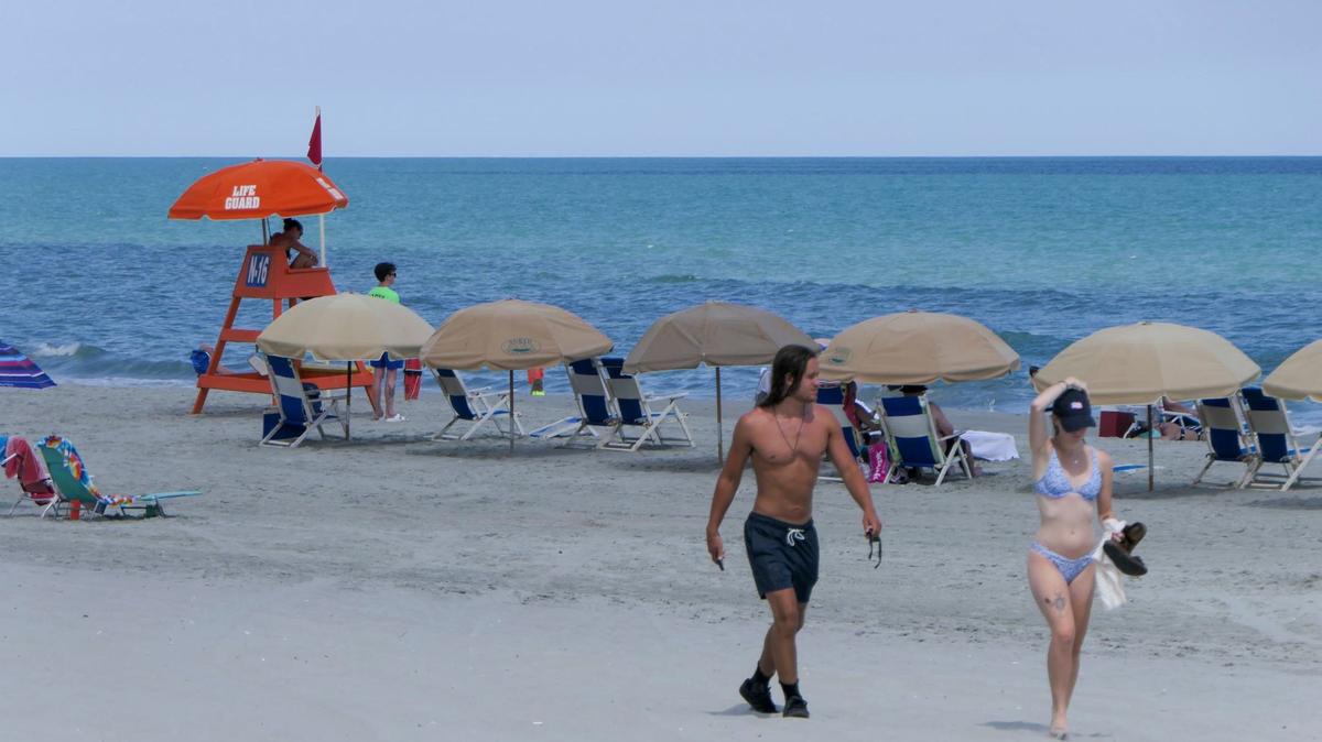 An image of people walking along the beach at Myrtle Beach.