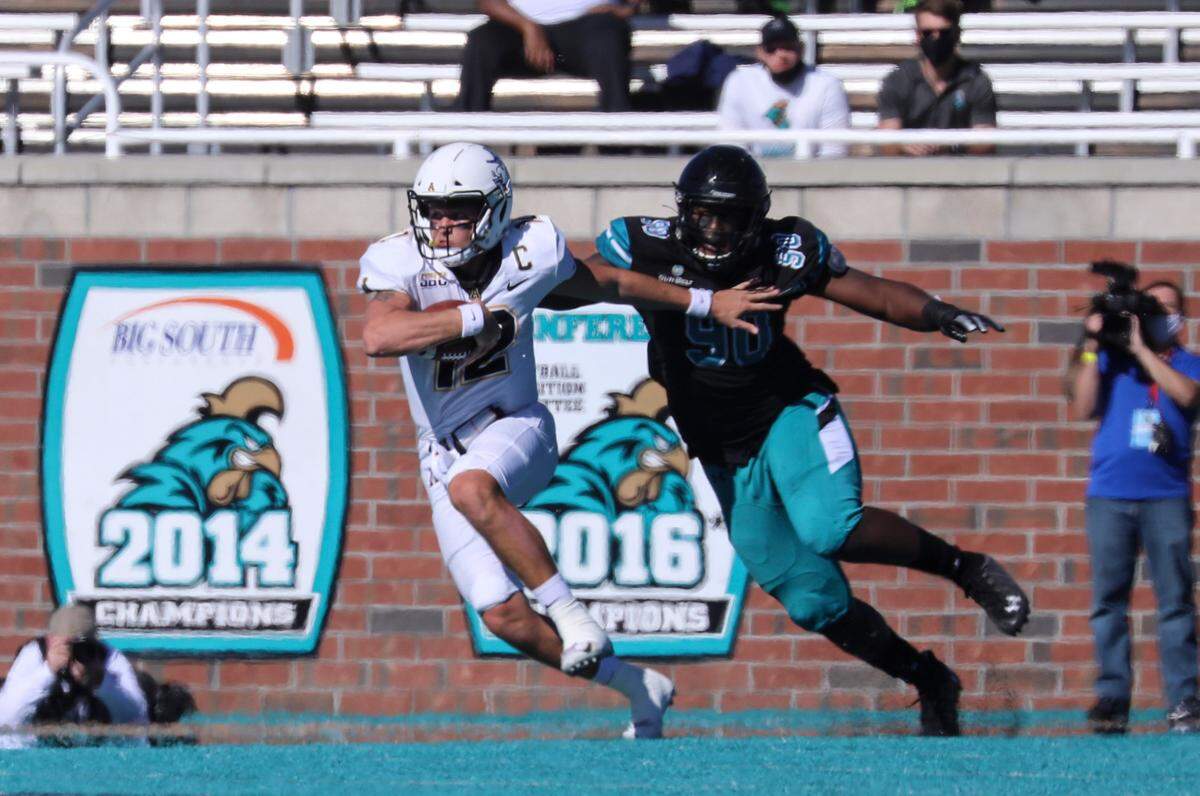 Appalachian State’s Zac Thomas tries to break away from Coastal’s Rolan Wooden II. Coastal Carolina played Appalachian State with first place in the Sun Belt Conference’s East Division on the line on Nov. 21, 2020 at Brooks Stadium in Conway.