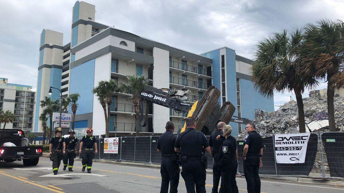 A Myrtle Beach hotel was evacuated Monday after a crane at a nearby construction site overturned and fell into the building.