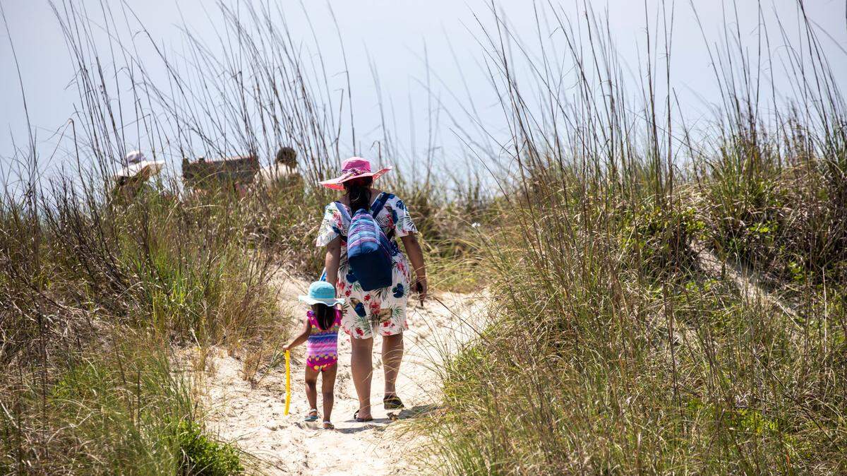 A family makes their way across the dunes in Atlantic Beach. June 13, 2022.
