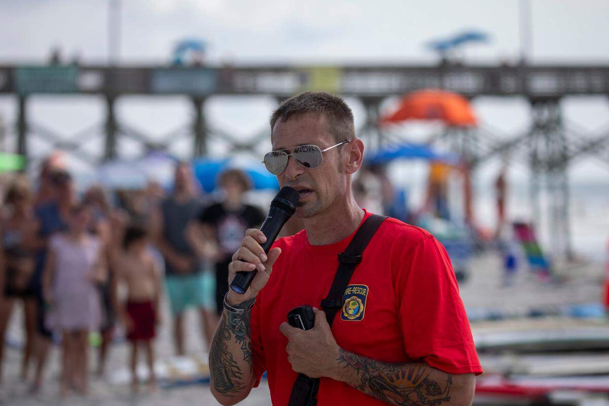 A paddle out ceremony and celebration of life was held on the beach in Garden City on Saturday for Lt. Matthew A. Piontkowski who died of cancer on June 9, 2023. Fellow firefighters, police officers, friends and family joined in the traditional ceremony that included paddling surfboards out into a circle, sharing remembrances and places flowers in the water in his honor. July 15, 2023.
