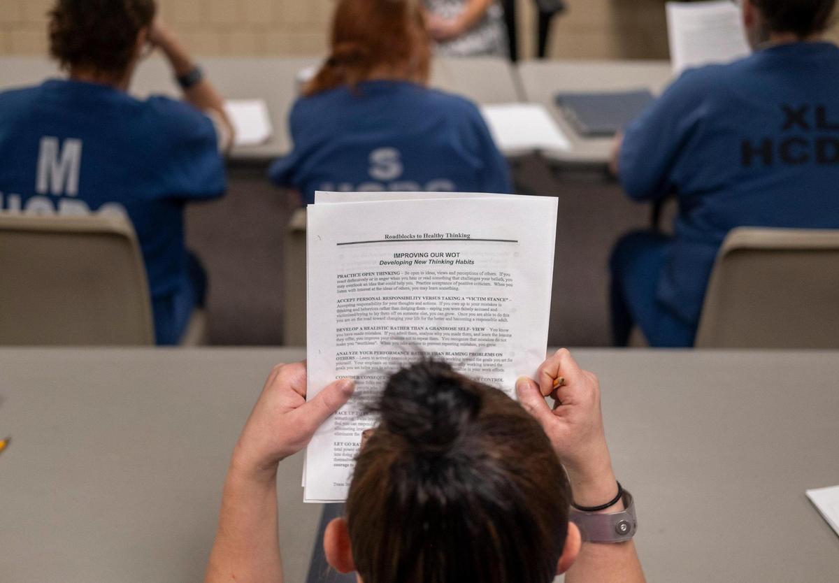 A female detainee at J.Reuben Long Detention Center, reads class notes on addiction recovery during a “Next Step” class at the jail. Female detainees are able to take part in “Next Step” addition recovery classes as part of the jail’s new pretrial intervention program specifically tailored to women.. July 5, 2023.