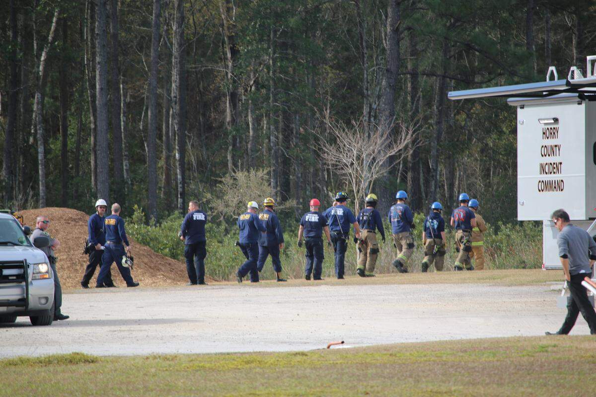 Searchers look for a missing man near the library in Carolina Forest.