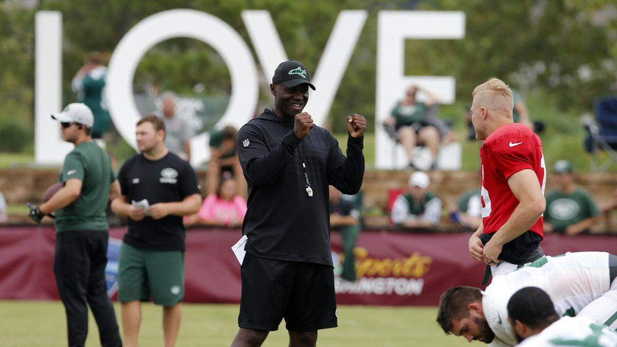 New York Jets head coach, Todd Bowles, center talks with quarterback Josh McCown (15) during the New York Jets Washington Redskins NFL football training camp in Richmond, Va., Monday, Aug. 13, 2018. (AP Photo/Steve Helber)
