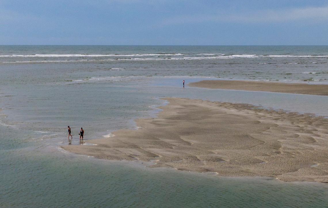 Beach goers enjoy the sand bars and tidal pools at the tip of Cherry Grove in North Myrtle Beach, S.C. The area, also known as Cherry Grove Point, has sand bars and tidal pools exposed during low tide. June 12, 2024.
