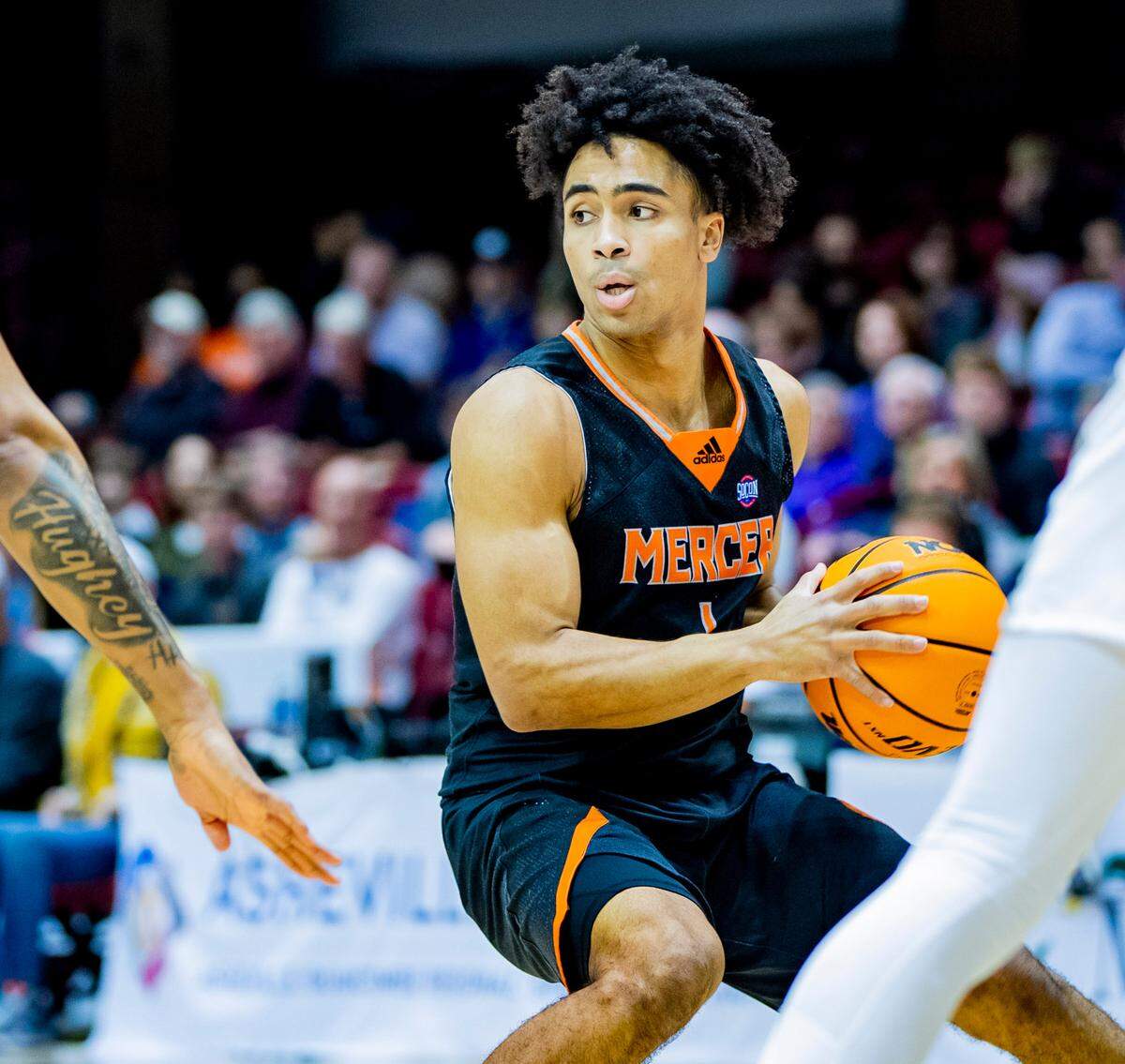 Mercer junior guard Kamar Robertson looks to pass against Furman Saturday afternoon in the SoCon Ingles Basketball Championships at the Harrah’s Cherokee Center in Asheville, N.C.