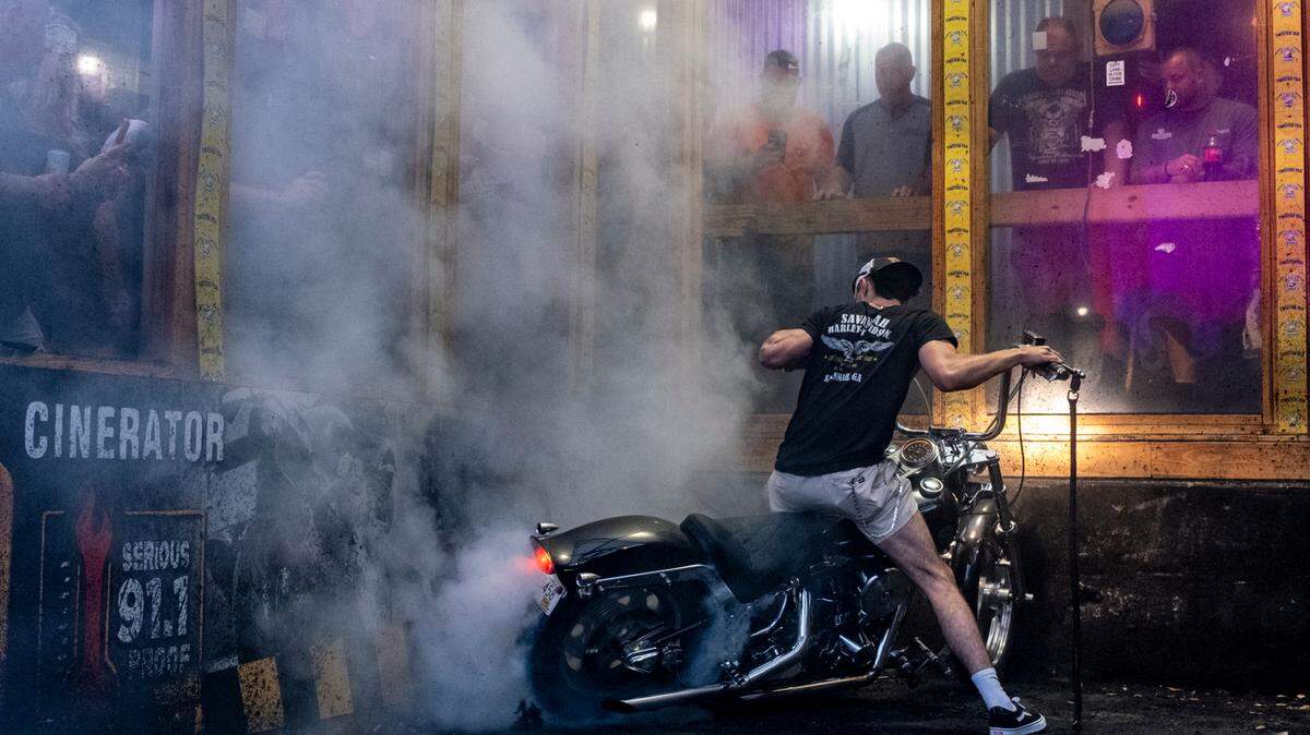 Bikers compete in the burn out pit at Suck Bang Blow bar in Murrells Inlet, S.C. during the 2024 Myrtle Beach Spring Rally. Their spinning tires burn rubber often shredding tires and filling the air with smoke, the roar of engines and the cheers from the crowd. May 16, 2024.