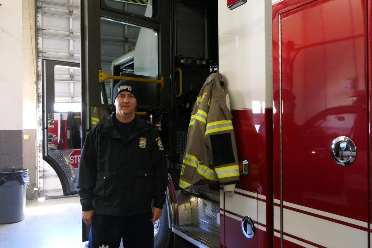 Firefighter Jack Todd stands next to a Myrtle Beach fire engine. He spent Christmas day away from his wife and son, but said he was making the most of the day.