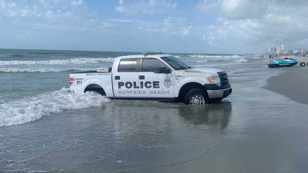 Surfside Beach patrol vehicle stuck in surf on Monday, July 12, 2021.