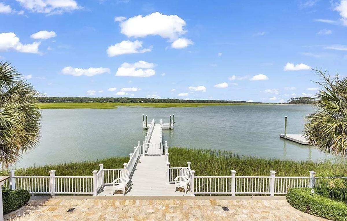 A $1.7 million house is listed for sale on Zillow. The home in North Myrtle Beach is nestled between 30-foot palm trees and features an elevator and dock.