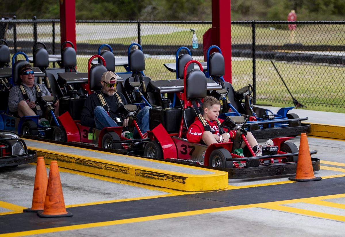 Broadway Grand Prix visitors wait to begin a race at the track, located across the street from Broadway at the Beach on March 16, 2020. The go-kart park is among the area businesses that has been forced to cut its hours because of a shortage of employees.