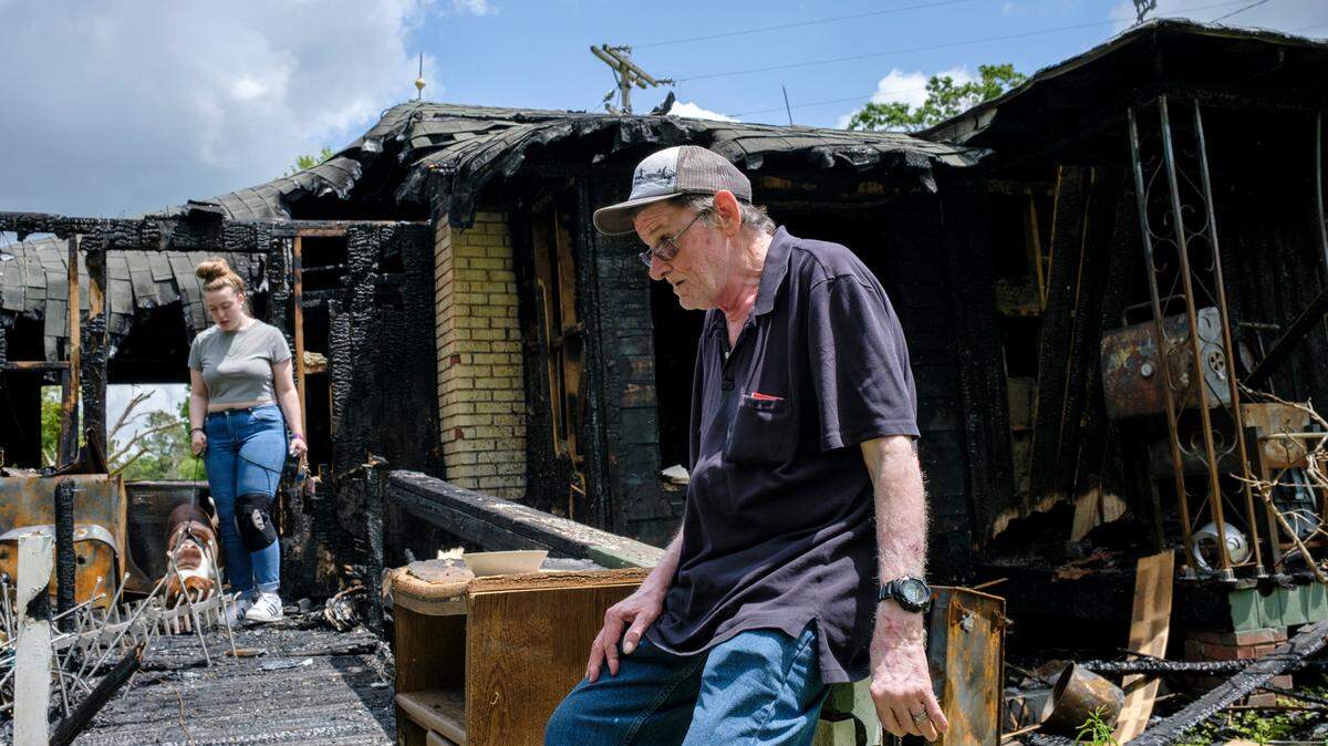 Joey Godwin takes a break from looking through his fire damaged home in Georgetown County, S.C. While looking through wreckage of their fire ravaged home, family members recount how off-duty Myrtle Beach firefighter Nate Ellis rush to save them from the flames. April 27, 2023.