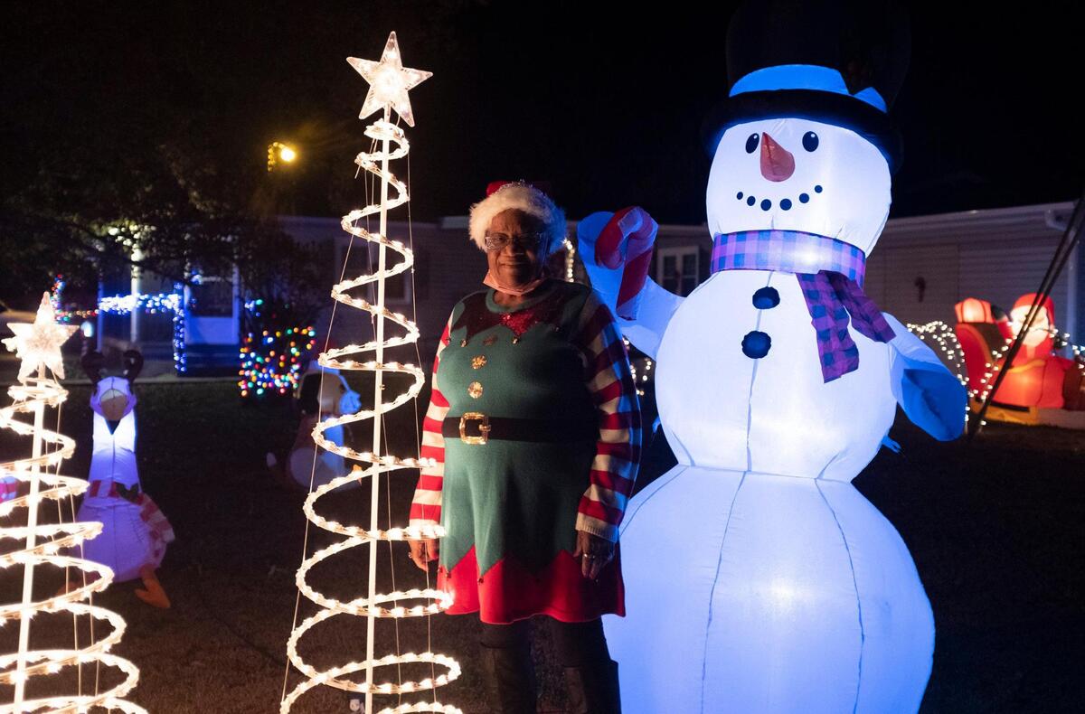 Hattie Williams stands amount her Christmas decorations on Williamson Road in Longs. The Freemont subdivision in Longs has been lit in Christmas lights with residents hoping to spread holiday cheer to a neighborhood that has been trouble by violence and the spread of COVID-19 this year. December 17, 2020.