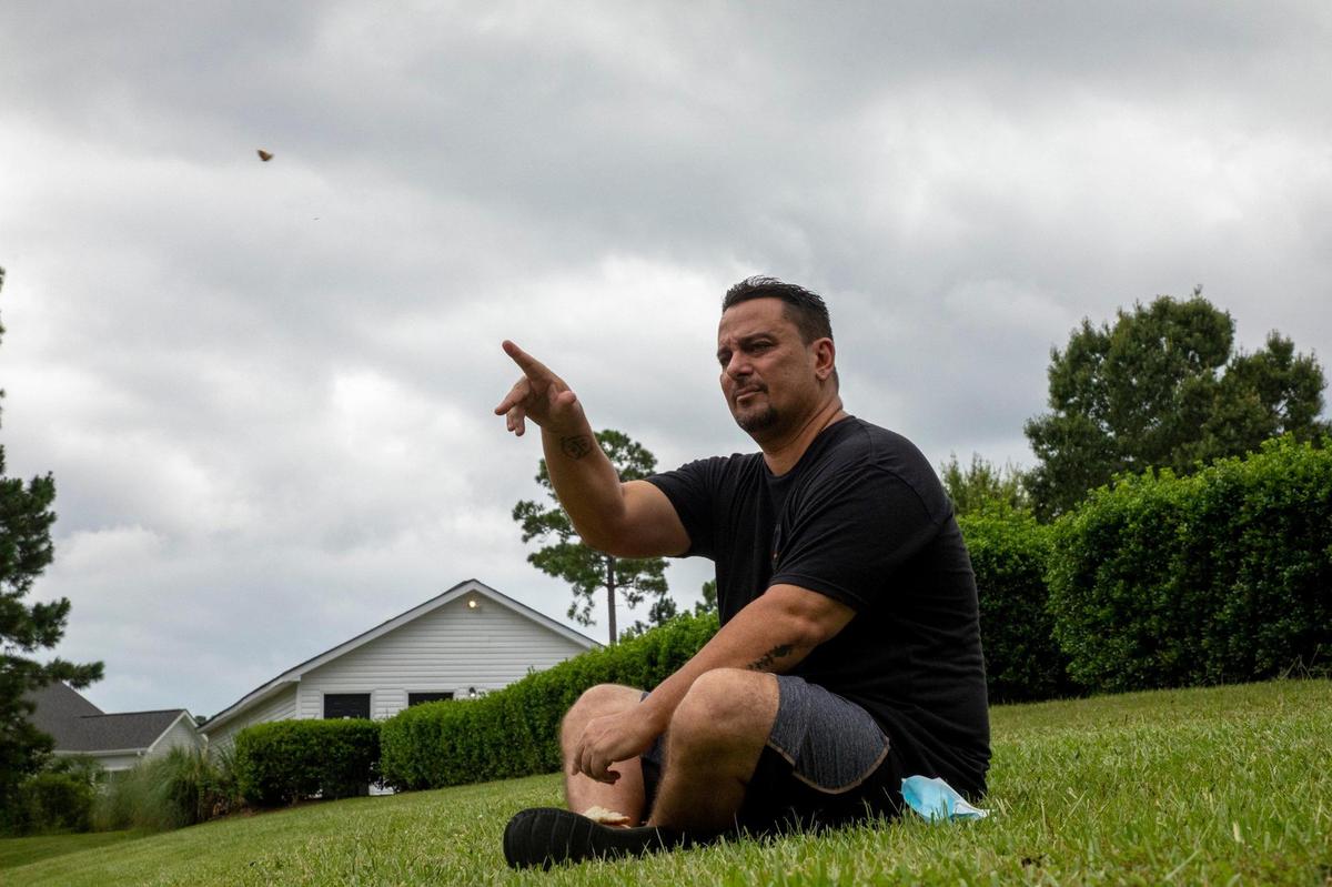 Rafael Colon tosses bread crumbs to turtles in the pond near his apartment, one of his few outside activities since he tested positive for the coronavirus. Colon, a salesman is out of work, isolating at home and was struggling to pay rent when the Eastern Carolina Housing Organization came to his aid. Some Myrtle Beach area residents are struggling to pay rent and avoid homelessness during the coronavirus pandemic.July 30, 2020.