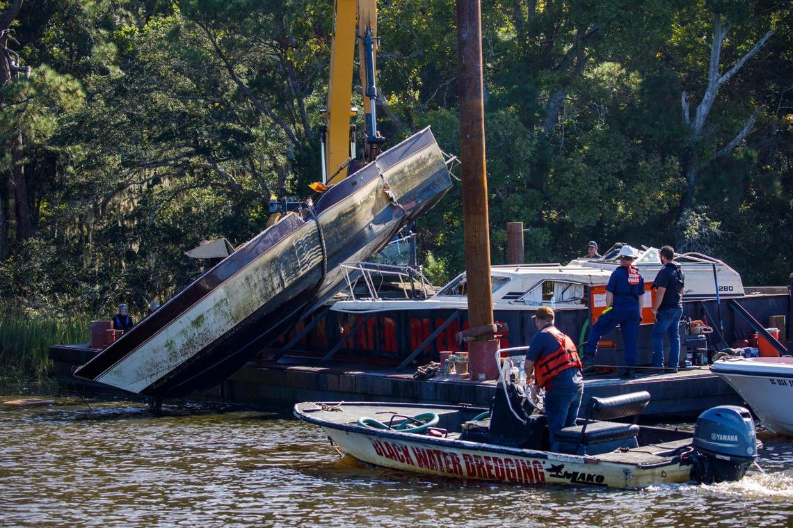 A team of volunteers from Black Water Dredging and conservation group Wounded Nature Working Veterans assist the SCDNR with the removal of abandoned boats at Little River near the Horry County line. Abandoned boats litter the waterways throughout Horry County, S.C. The Department of Natural Resources is partnering non-profit conservation groups and local businesses to begin removing the derelict vessels from local waterways. Oct. 20, 2021.