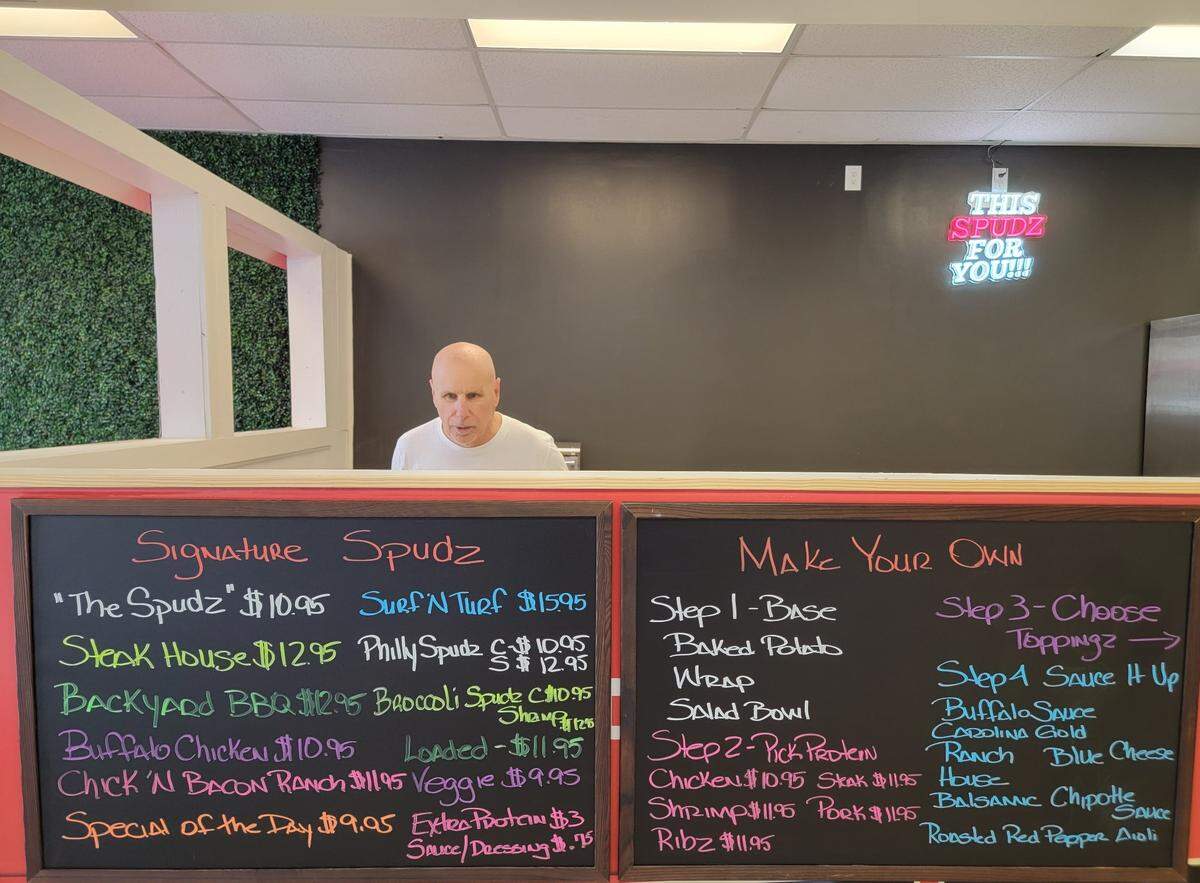 Owner Tim Wright behind the counter of Spudz and Saladz on Monday, Nov. 18.