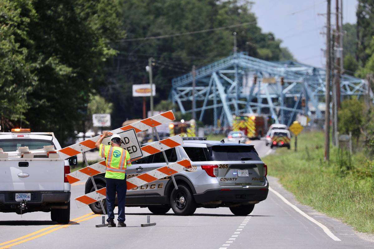 The swing bridge in Socastee, SC is closed as fire and police personnel work to recover a submerged vehicle.