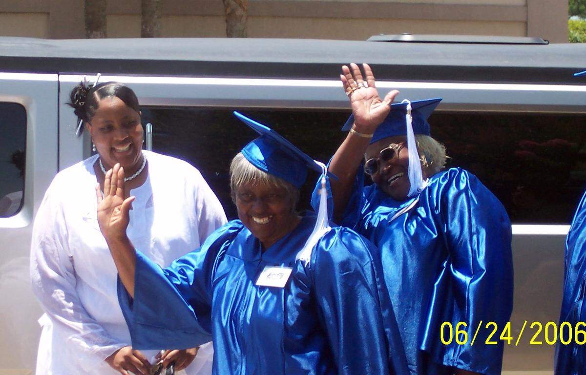 April Johnson escorts alumni of the Myrtle Beach Colored School to the new museum building. The group were given ca and gown and a limo ride to the ribbon cutting.