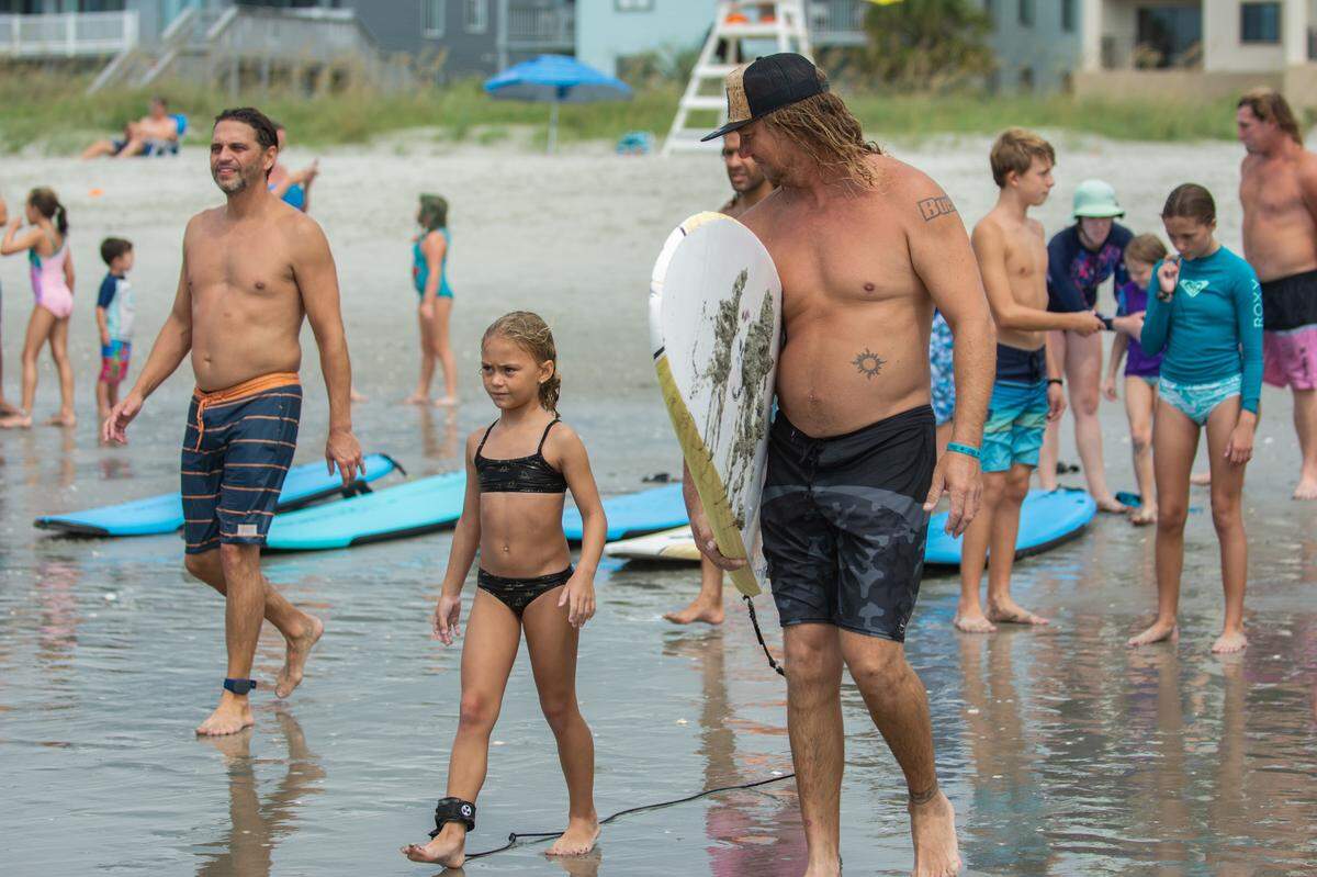 Volunteers took more than 100 kids out to learn to surf in North Myrtle Beach on Au.g 7, 2021, for Take A Kid Surfing Day.