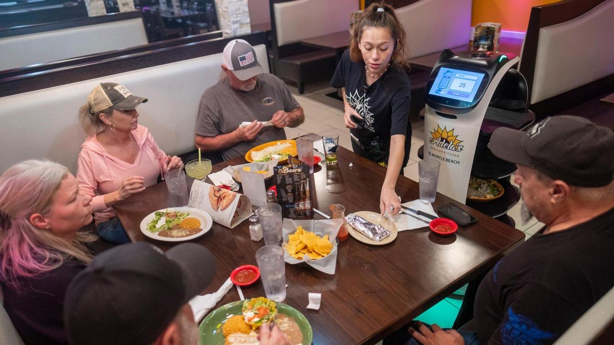 Robotic waiters carry food to tables at Adela’s Mexican Kitchen, in North Myrtle Beach, S.C. The “Bellabots” made by the ToDo electronics are styled with cat faces and ears, provide interactive entertainment and can carry up to eight plates from the kitchen to tables in the restaurant. Jan. 25, 2024.