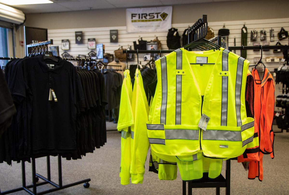 Safety vests and other various apparel hang on racks at Cormac Arms & Outfitters on 38th Avenue in Myrtle Beach. In addition to gun sales and apparel, the new tactical shop supplies law enforcement agencies with tactical gear.