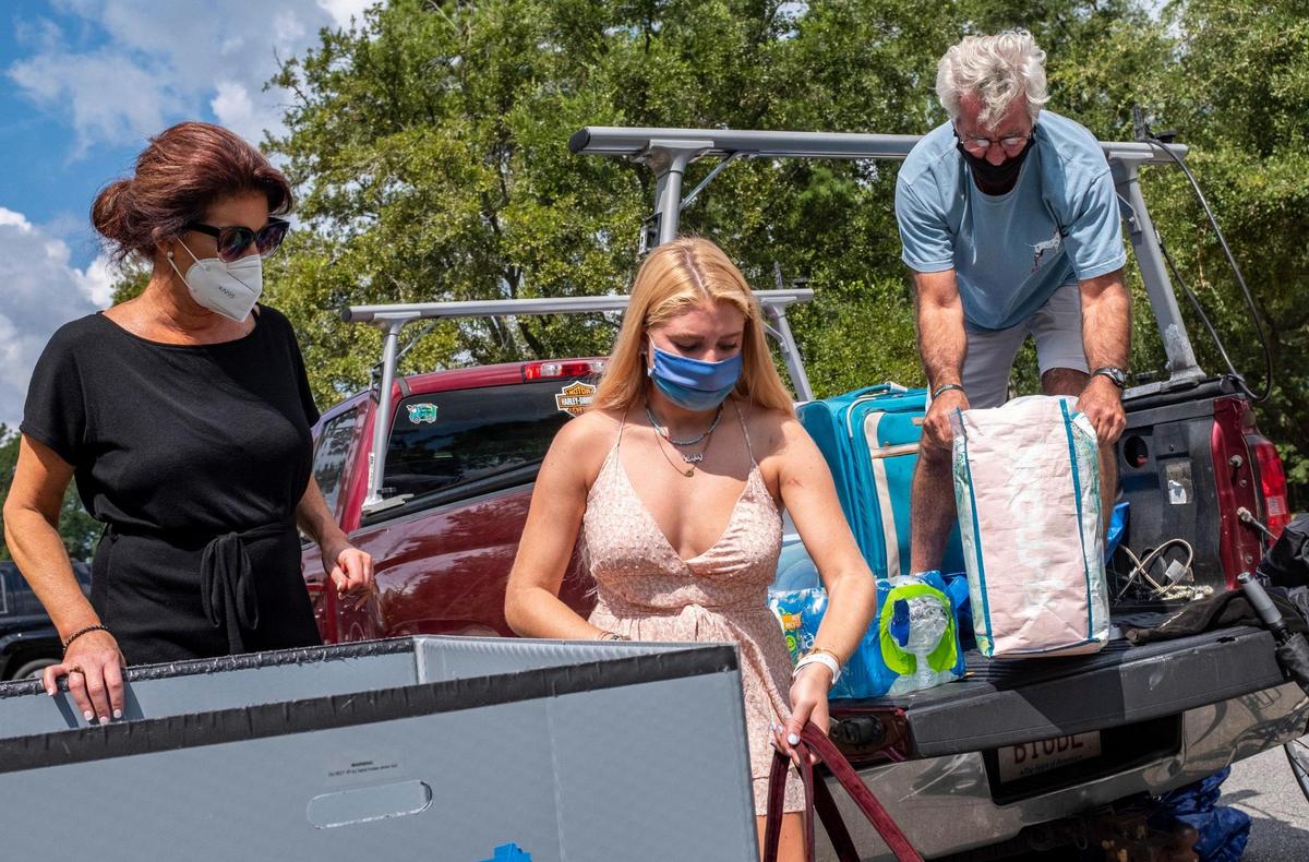 Olivia Sheehan of Newburyport, Mass gets help unpacking at Coastal Carolina University from parents Pamela and Scott Sheehan. Wearing masks and following various protocols in an attempt to protect them from the coronavirus pandemic, students began moving into campus housing at Coastal Carolina University today. Over 4,000 students have elected to live on campus this semester and will continue moving in over the next few weeks. August 12, 2020.