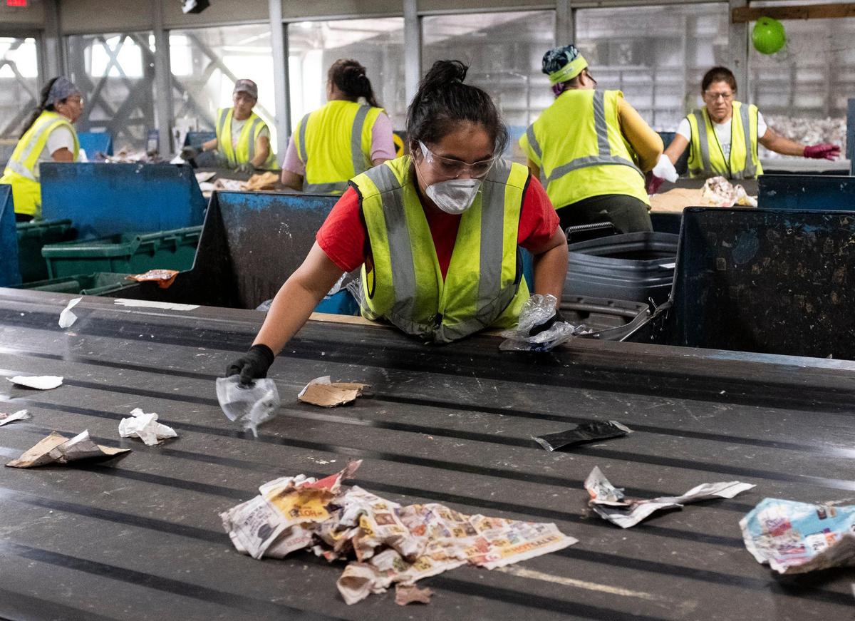 A worker sorts out recyclables at the Material Recycling Facility (MRF). The facility handles 21,000 tons of recyclables a year with only a 14-15% rejection rate.