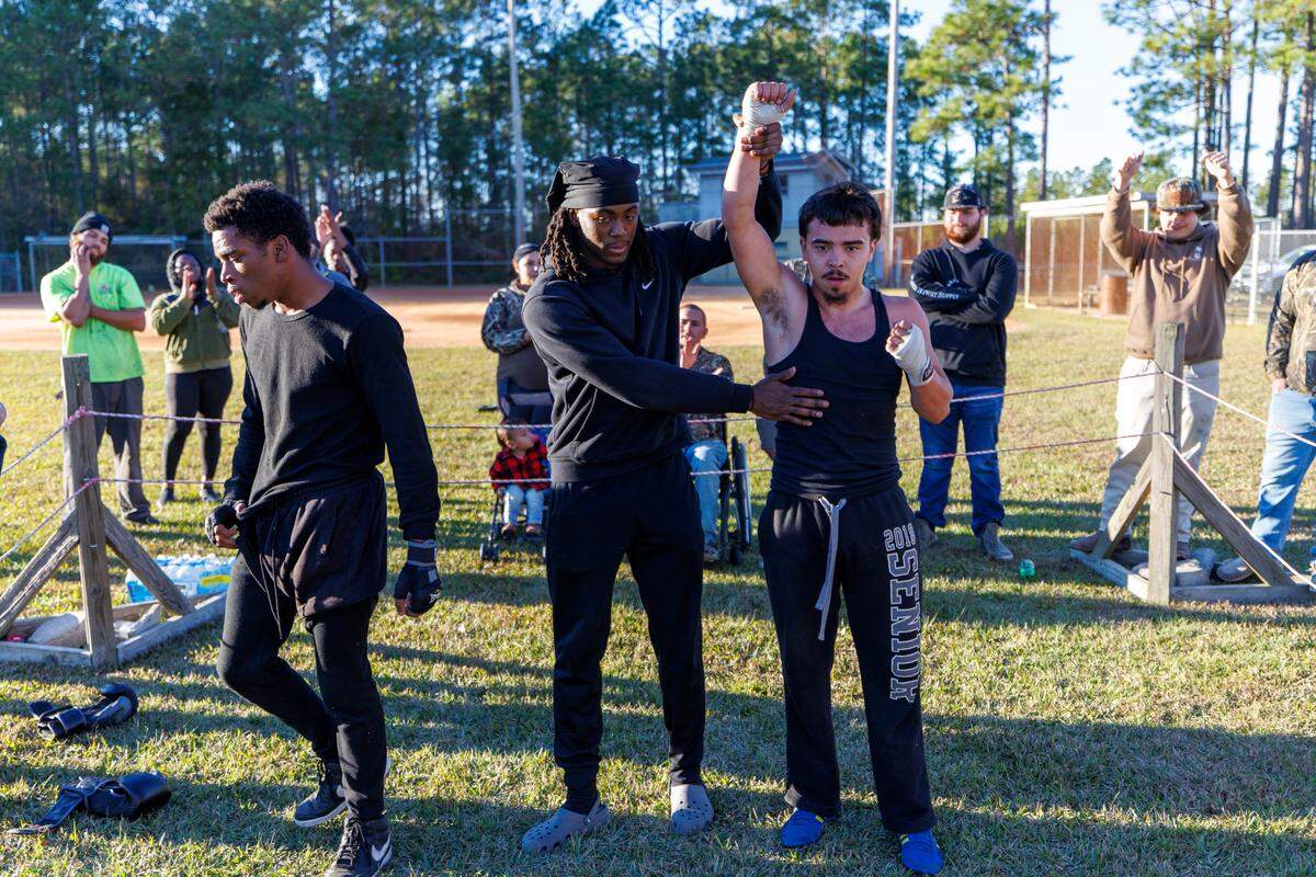 Jeramiah “Jumbo” Ledesma is declared the winner against Alex Bowman during a Carolina Fight Club event. Carolina Fight Club with the motto of “Guns “down, gloves up” was founded by Nate Jenkins and four friends in 2019, as a way to safely settle differences and hone the craft of boxing. The matches, open to anyone who wants a fair fight, are held in backyards and community parks in rural Horry County, S.C. Nov. 23, 2024.